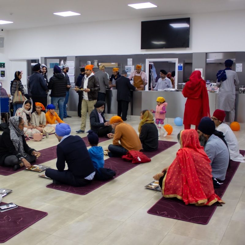 Families eating together in the Langar Hall